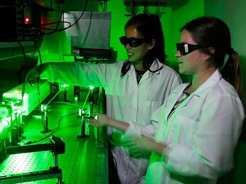 Grace Stokes and Jacenda Rangel 18 (Biochemistry) working in the laser lab.