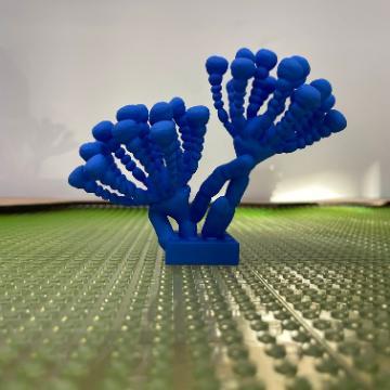 Blue LEGO coral-like structure on a green LEGO base.