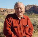 A person standing outdoors in a desert landscape.