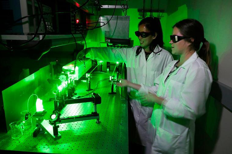 Grace Stokes and Jacenda Rangel 18 (Biochemistry) working in the laser lab.