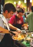 Two chefs cooking in a professional kitchen.