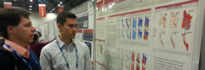Two people discussing a scientific poster presentation. 