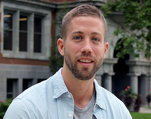 A person in front of a building labeled Tripp Strawbridge.