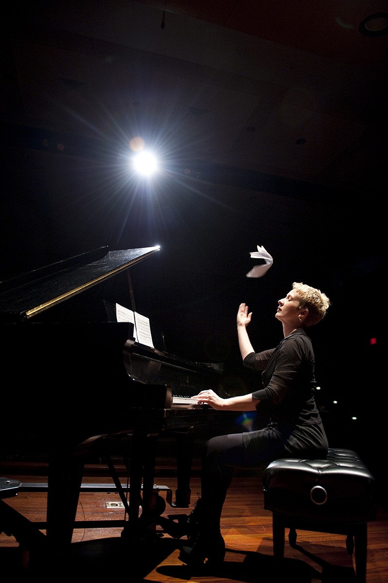 Teresa McCollough at the piano tossing music sheets