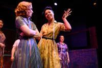 2 women in 1950s dress in a scene from The Pajama Game