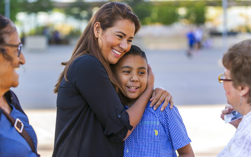 Immigrants from El Salvador hugging.