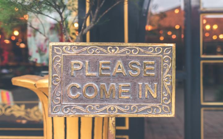 close up photo of antique brown please come in sign