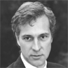 Black and white portrait of a man with a serious expression.