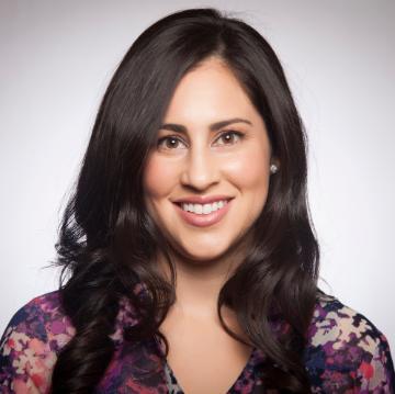 A person smiling in a studio portrait.