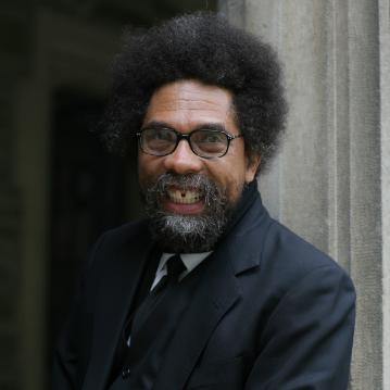 Cornel West smiling while wearing a black suit.