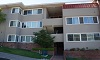 Three-story beige apartment building with balconies and windows labeled 2600 Virginia Street.