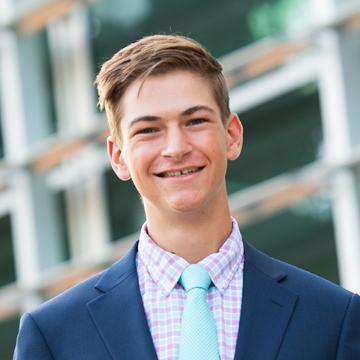 Man smiling in suit and tie