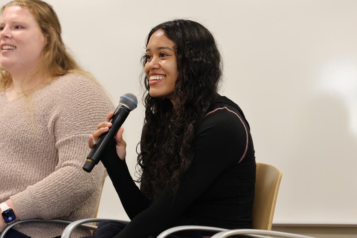Undergraduate business student and athlete on the womens basketball team smiling with microphone