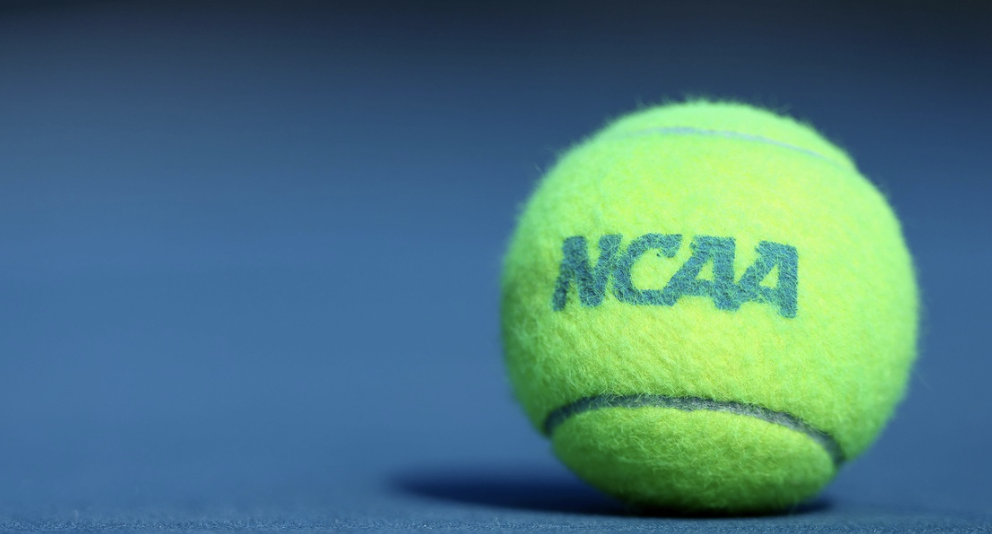 tennis ball on ground with ncaa written on it 