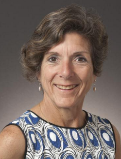 Woman in blue and white patterned dress smiling, titled Angela Robbiano - HOF Committee.