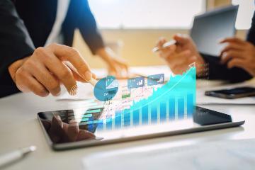 Financial analyst graphing performance over time