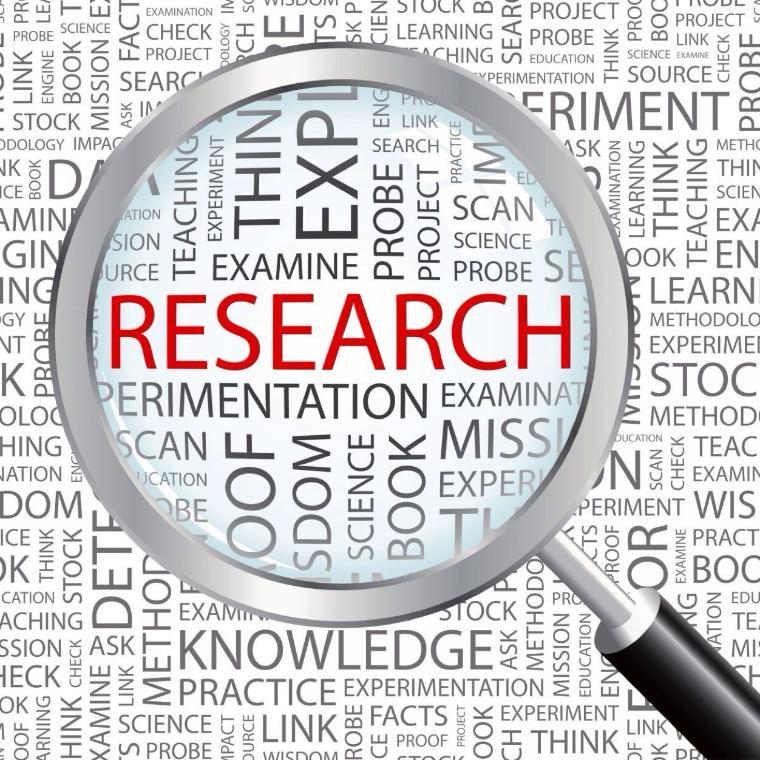 Magnifying glass focusing on the word Research