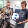 Bryce Mariano, left, and Paul Thurston show off the Oculus Rift and tablet that therapists employing their software can use to allay patients' fears.