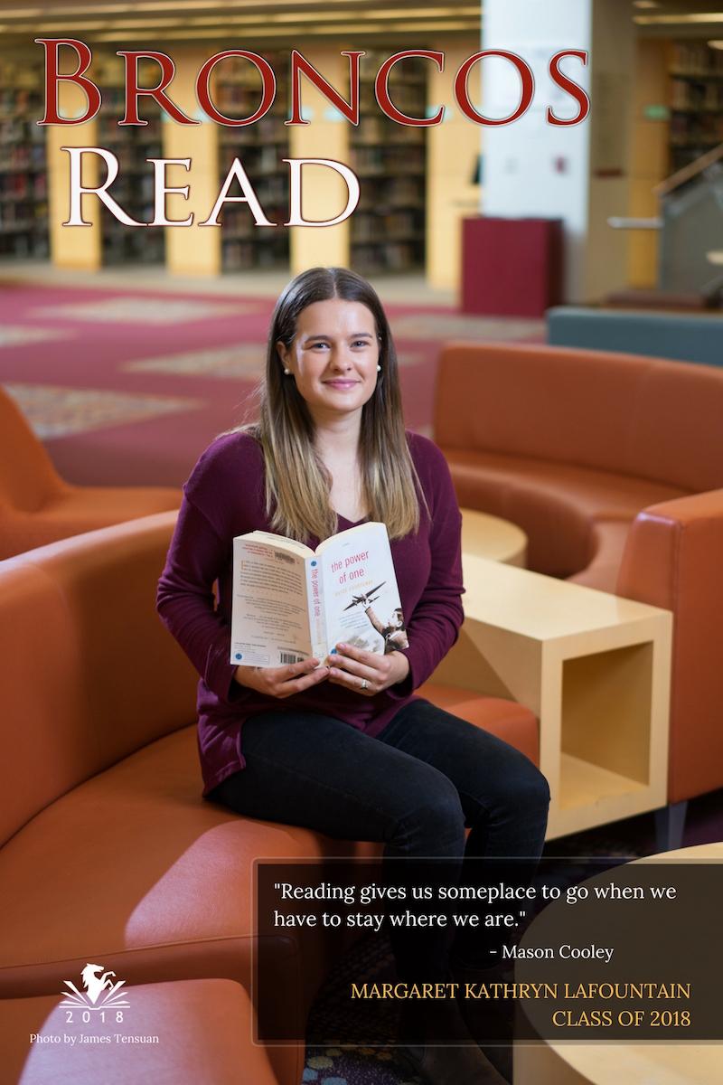 MK sitting and holding a book